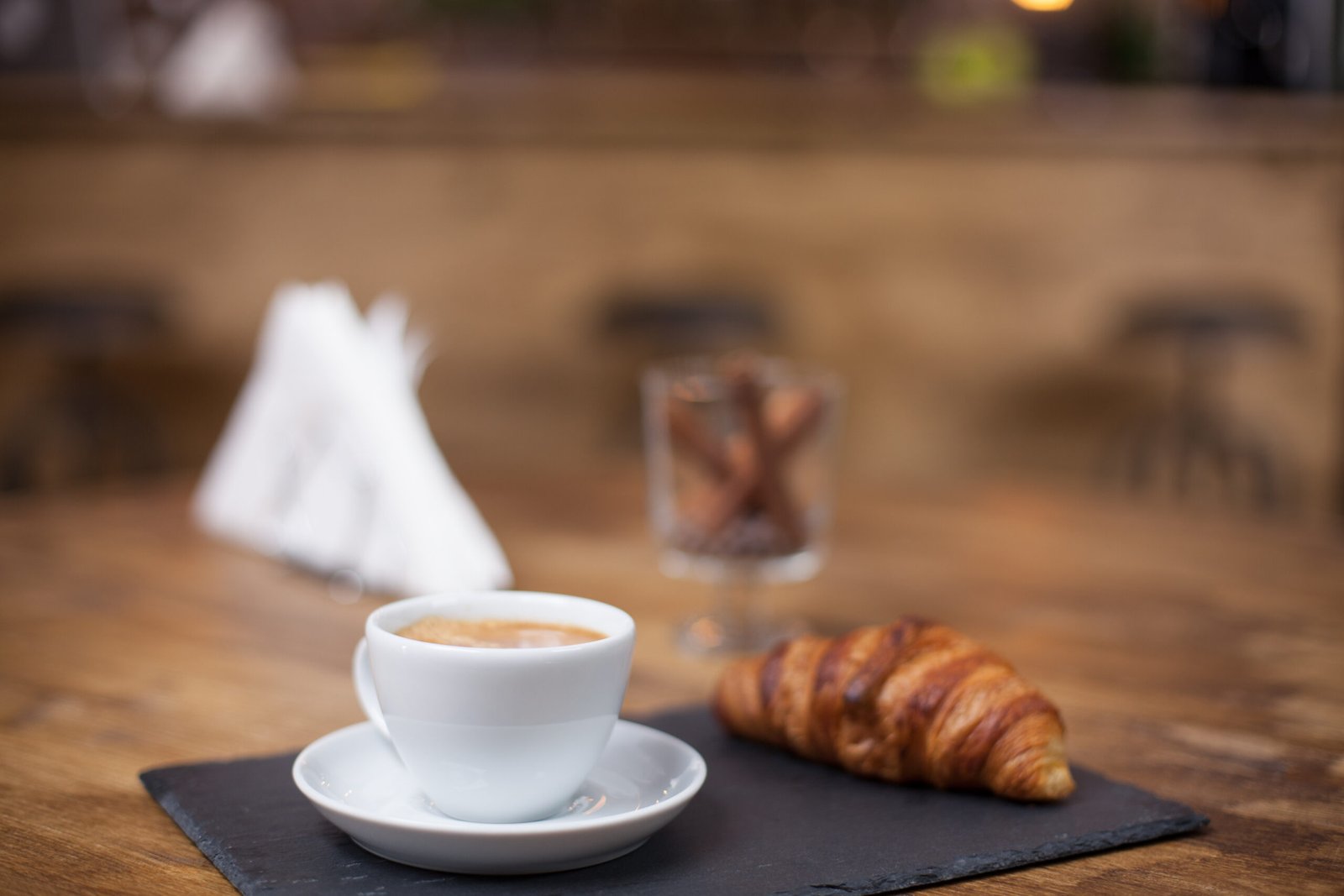 cappuccino coffee white cup wooden table delicious croissant tasty snak vintage coffee shop scaled
